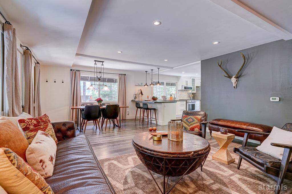 742 Kiowa Drive South Lake Tahoe, CA 96150 - Photo 9 of 26 a living room with furniture a clock and a chandelier