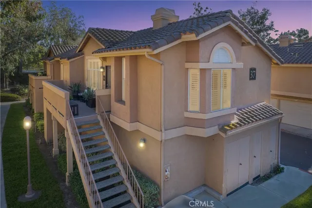 a front view of a house with balcony and garage
