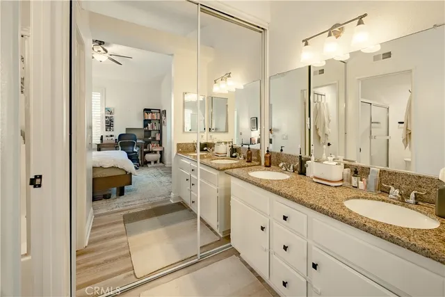 a bathroom with a granite countertop sink mirror and double