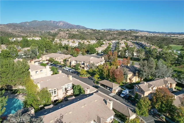 an aerial view of a house with a yard