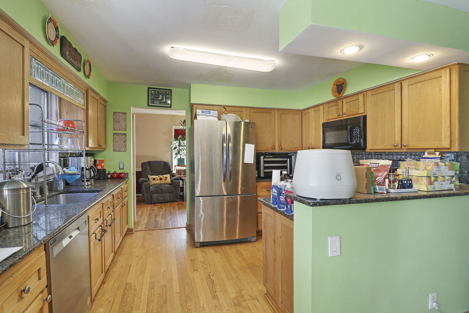 307 South Wulff Street Cary, IL 60013 - Photo 5 of 35 a kitchen with kitchen island a counter top space a sink a refrigerator and a cabinets