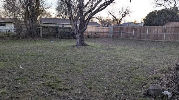 a view of a yard with a house and trees
