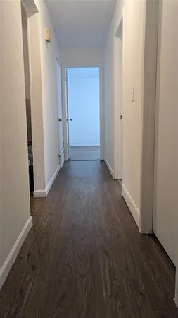 an empty room with wooden floor
