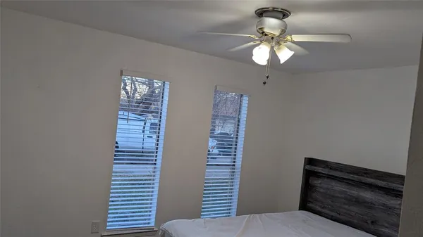 a view of entryway with chandelier fan and window