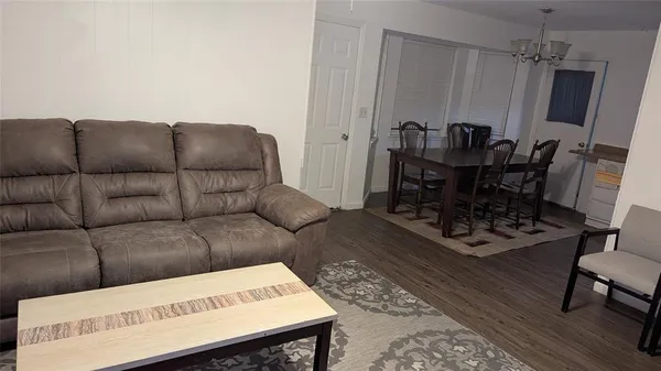 a living room with furniture a fireplace and a rug