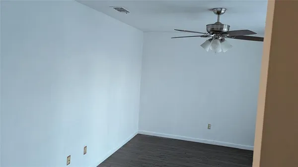 a view of a room with wooden floor