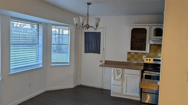 a view of cabinets with wooden floor and windows
