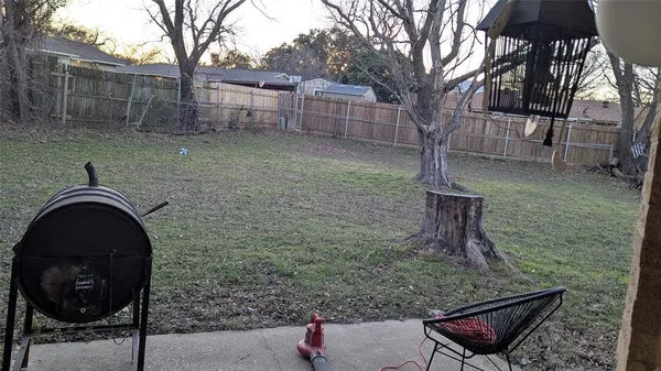 a backyard of a house with table and chairs