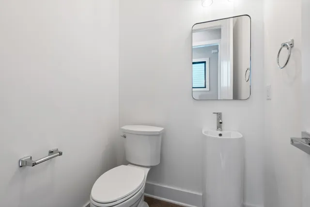 a white toilet sitting next to a bathroom sink