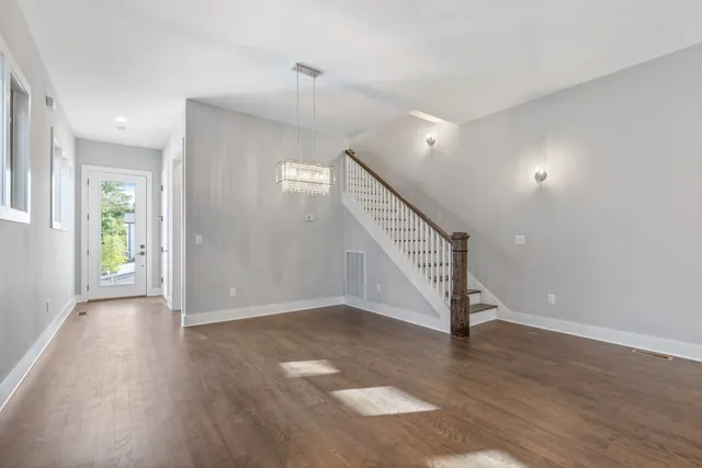 a view of an entryway with wooden floor