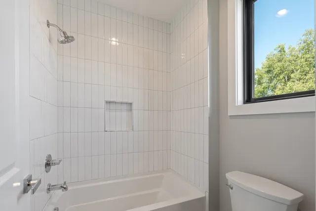 a bathroom with a bathtub and shower