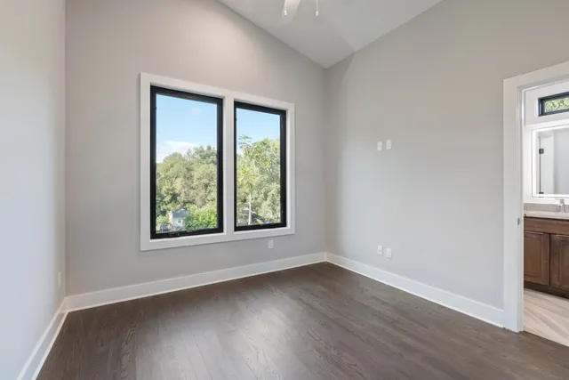 an empty room with wooden floor and a window