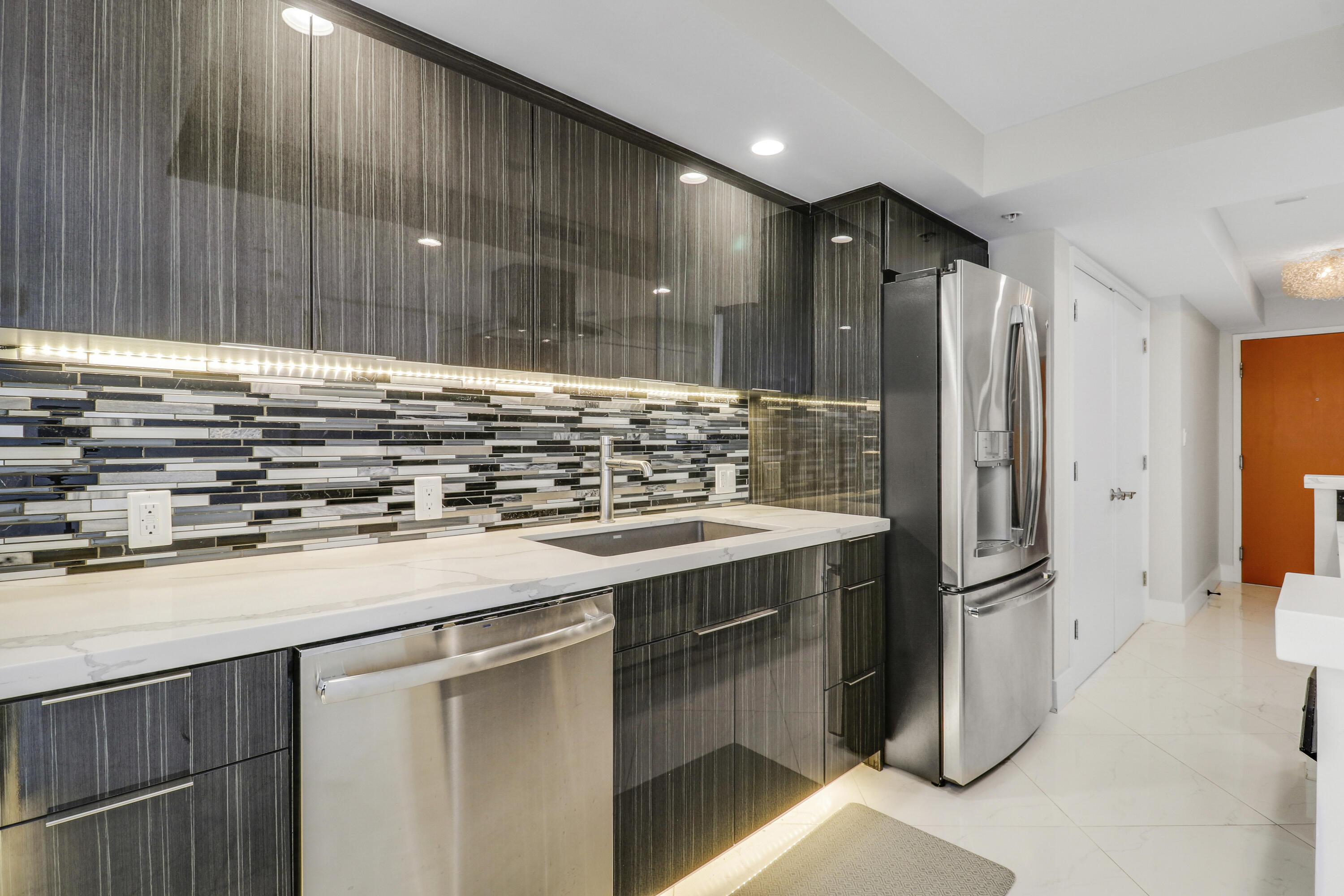 3000 North Ocean Drive, Unit 19H Singer Island, FL 33404 - Photo 13 of 43 a kitchen with stainless steel appliances granite countertop a refrigerator and a sink