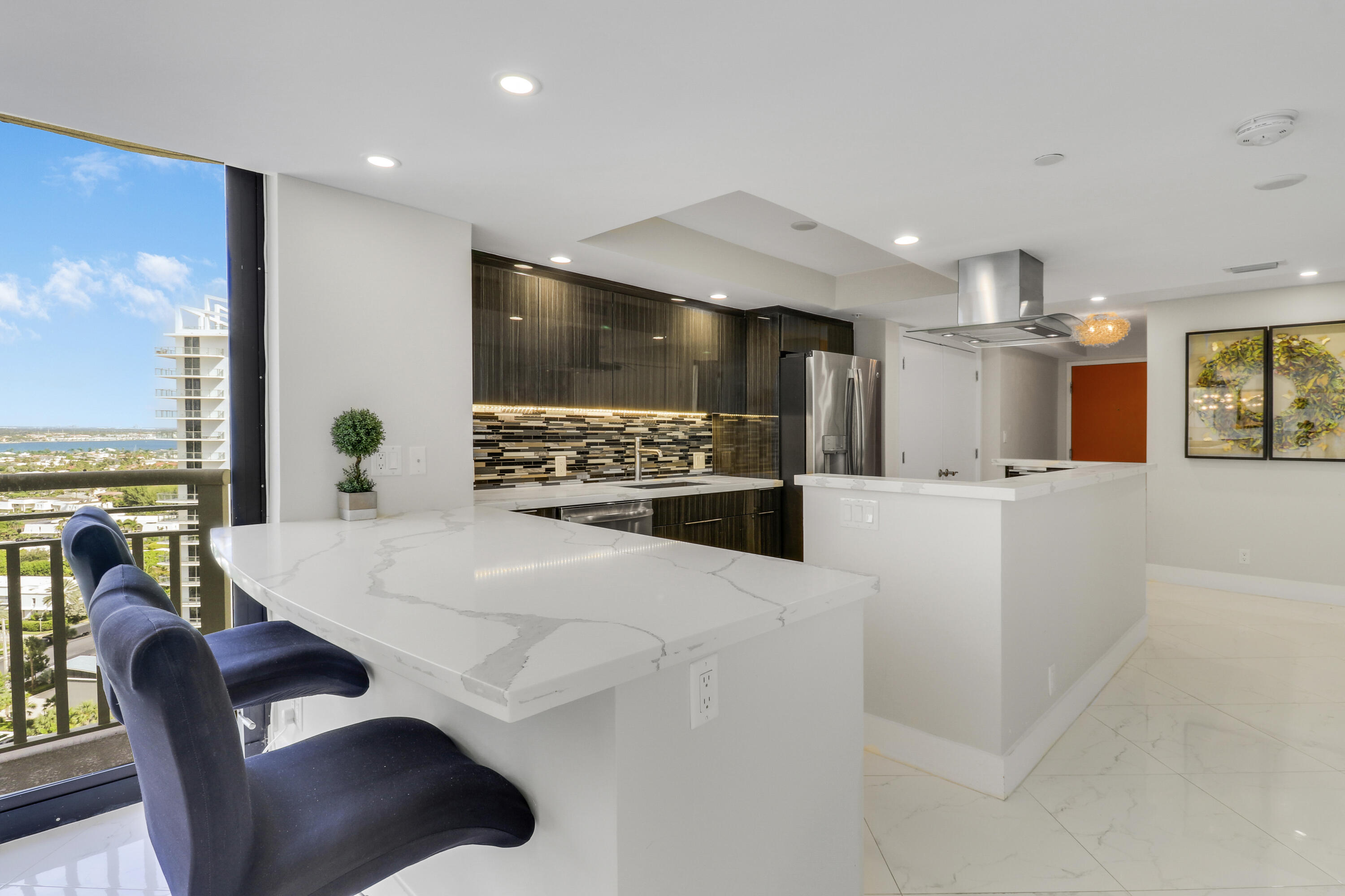 3000 North Ocean Drive, Unit 19H Singer Island, FL 33404 - Photo 18 of 43 a living room with stainless steel appliances kitchen island granite countertop a stove and a refrigerator