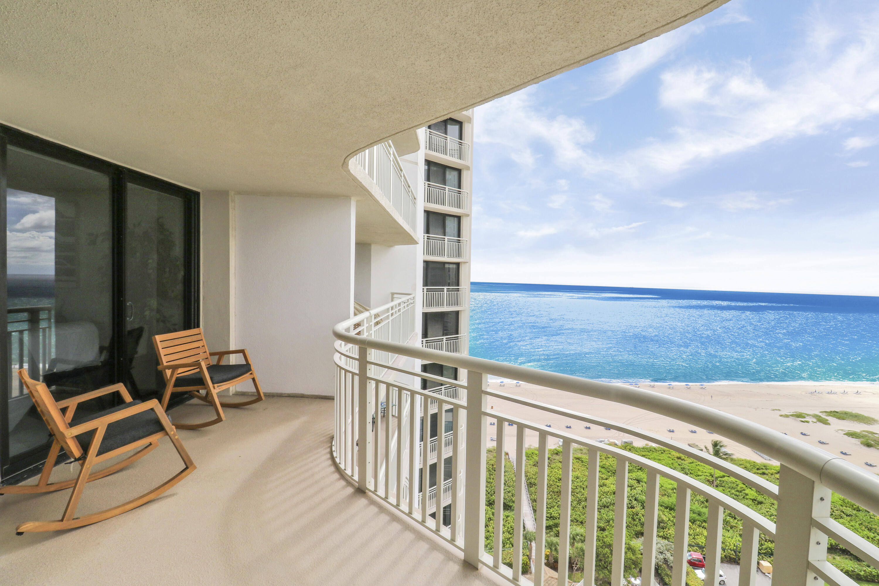 3000 North Ocean Drive, Unit 19H Singer Island, FL 33404 - Photo 34 of 43 a roof deck with table and chairs and wooden floor