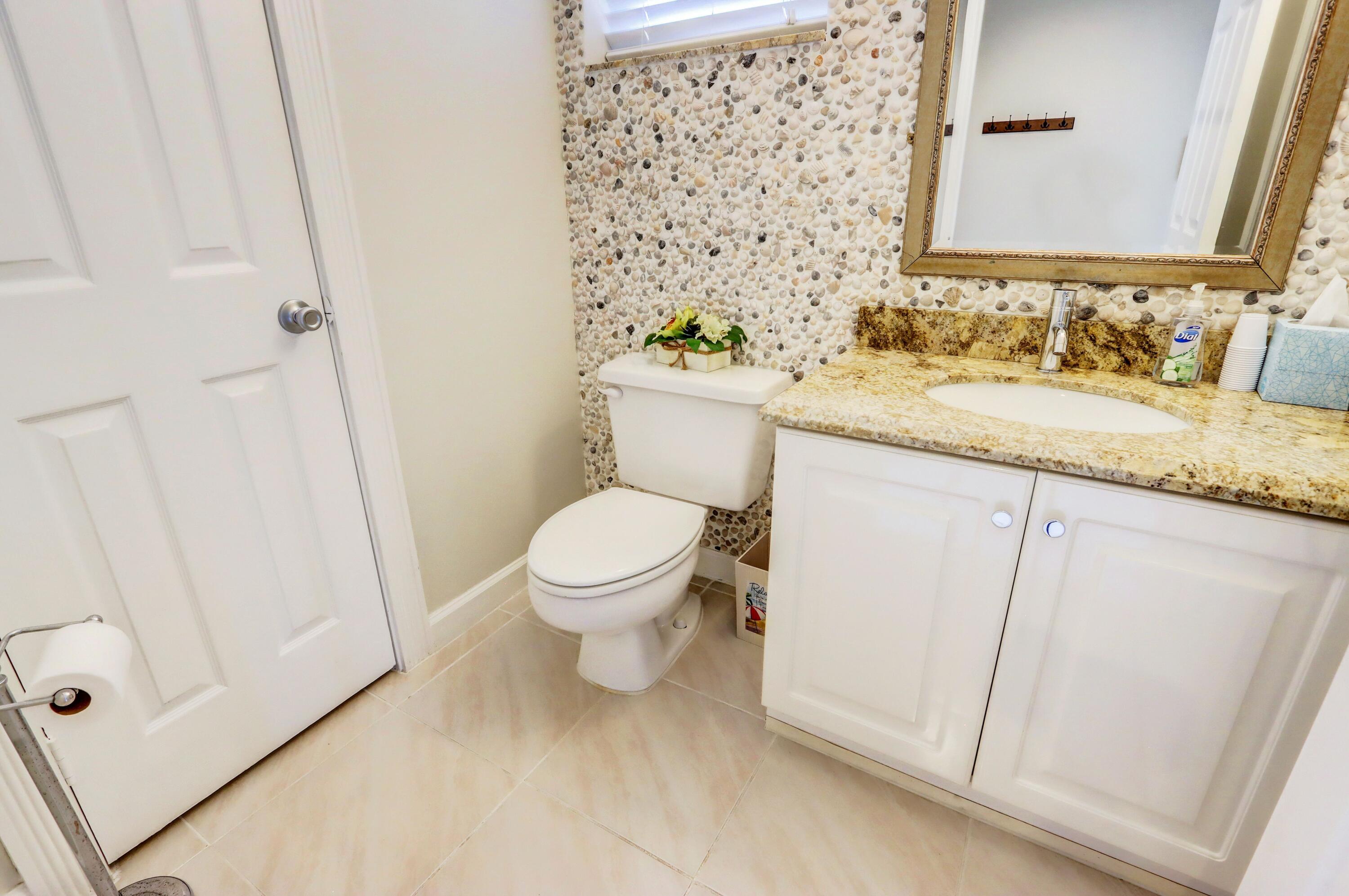 4075 Northwest 58th Lane Boca Raton, FL 33496 - Photo 6 of 24 Powder Room at Entrance