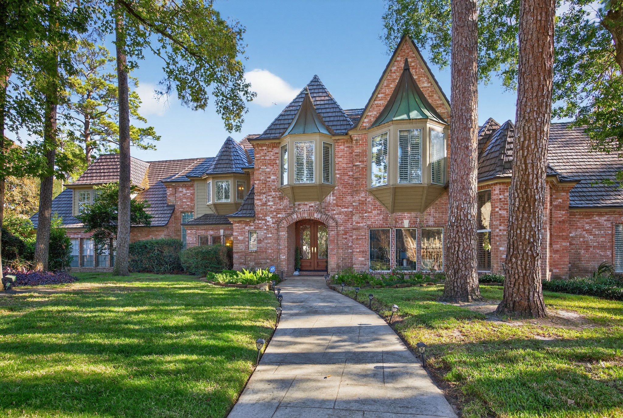 8807 Chelmsford Lane Spring, TX 77379 - Photo 3 of 50 The front walkway leads you to a double door entry of this gorgeous Champions Forest home