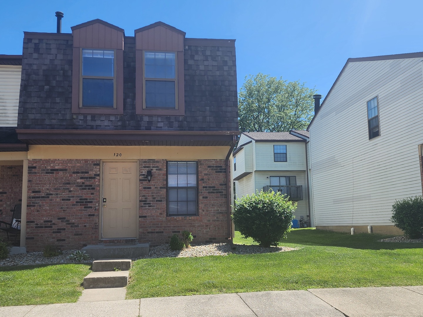 a front view of a house with garden