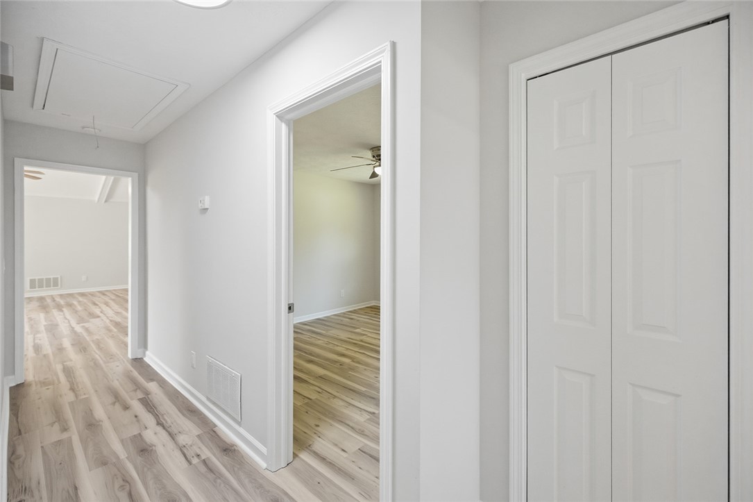 902 Cherokee Road Pelzer, SC 29669 - Photo 3 of 38 A bright hallway featuring durable wood flooring and crisp white trim.