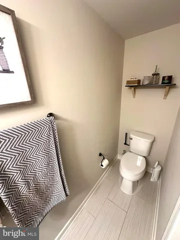 a bathroom with a toilet and a mirror
