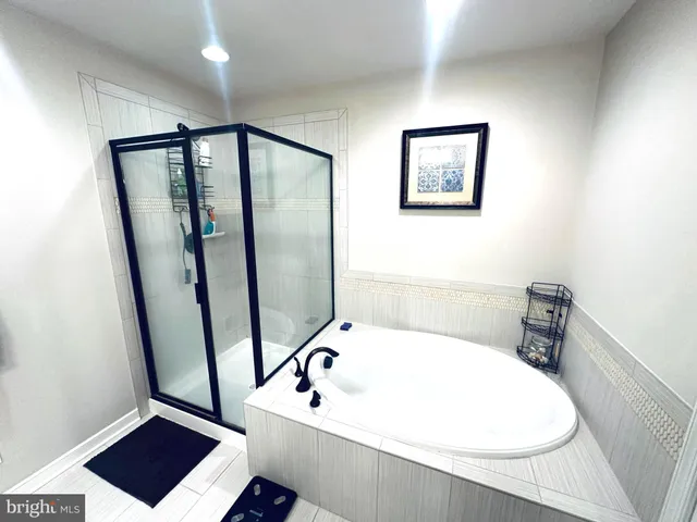 a bathroom with a bathtub and a shower