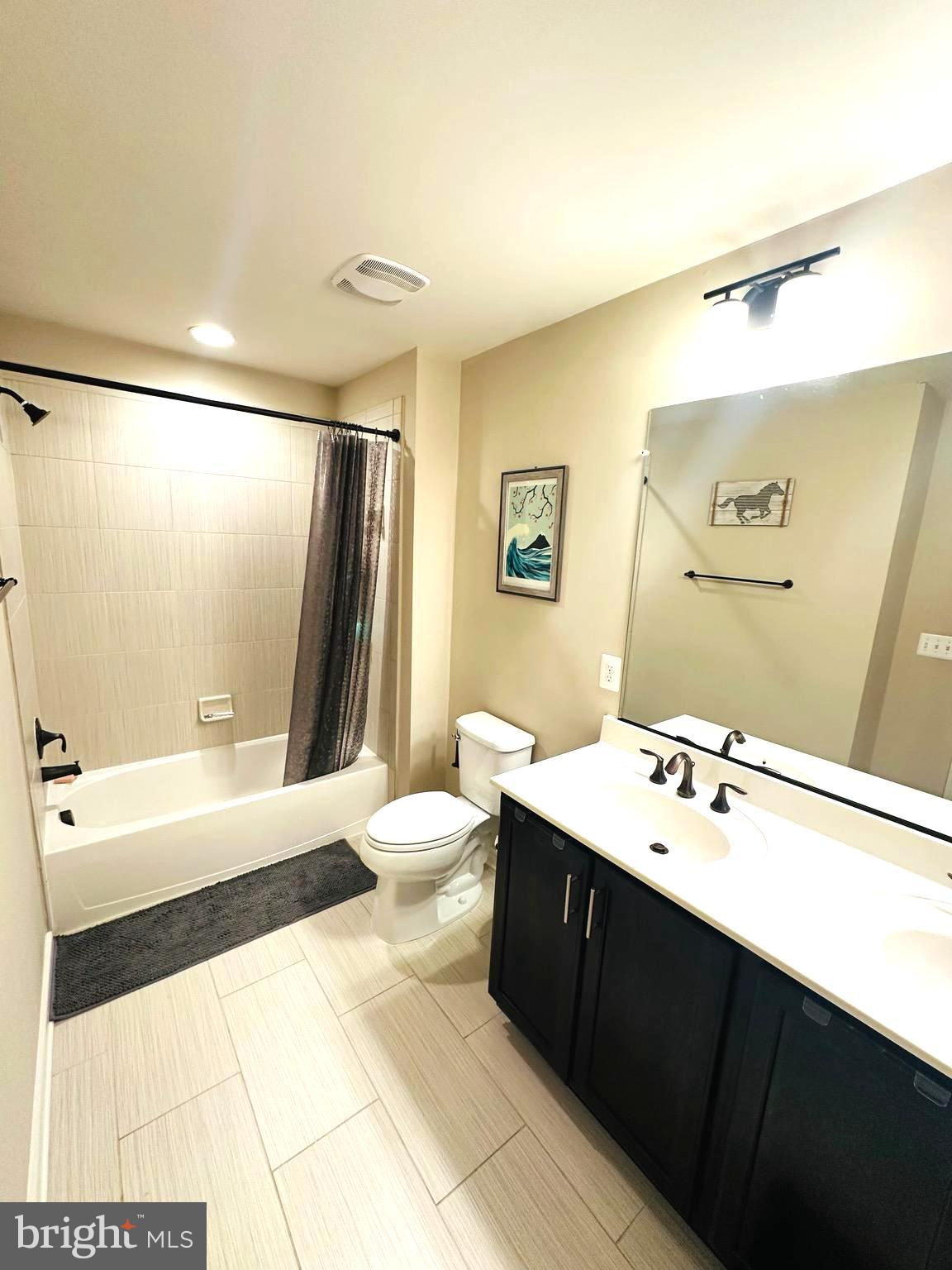 25576 Tolar Square Chantilly, VA 20152 - Photo 22 of 36 a bathroom with a sink a toilet a mirror and shower
