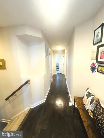 a view of a hallway to a livingroom with furniture