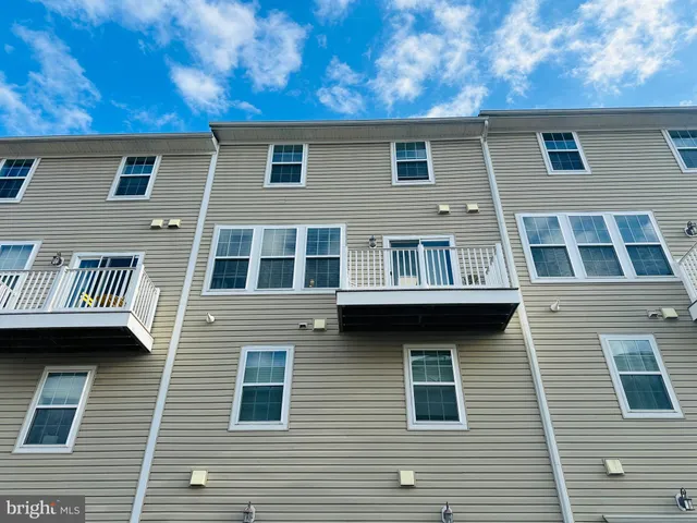 a large brick building next to a yard