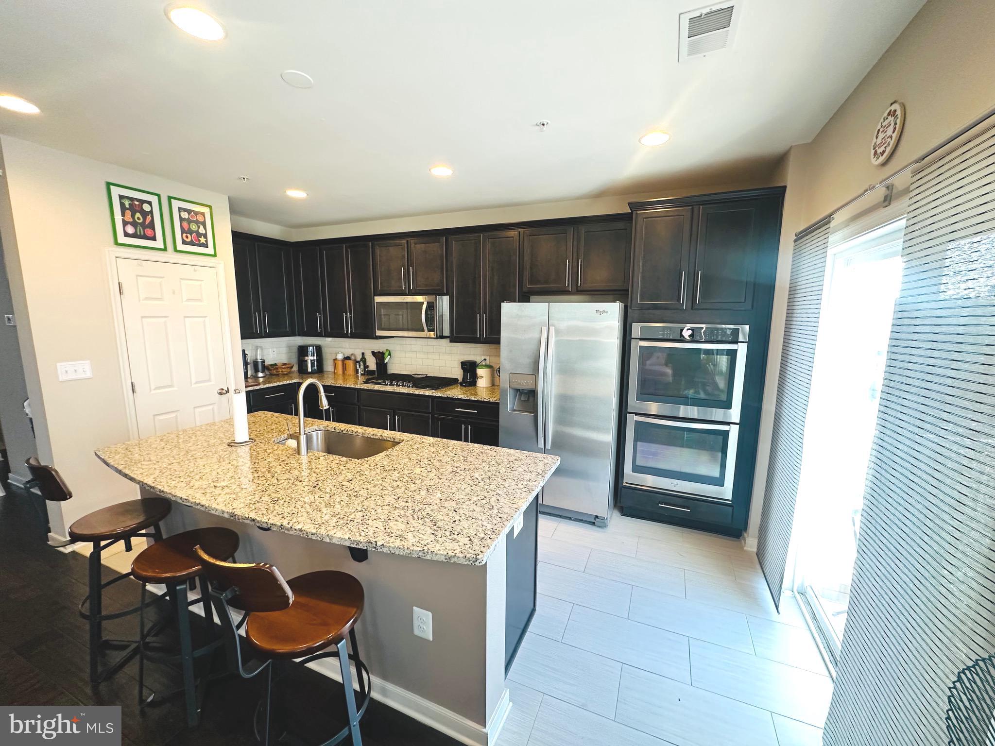 25576 Tolar Square Chantilly, VA 20152 - Photo 3 of 36 a kitchen with kitchen island a counter top space appliances and cabinets