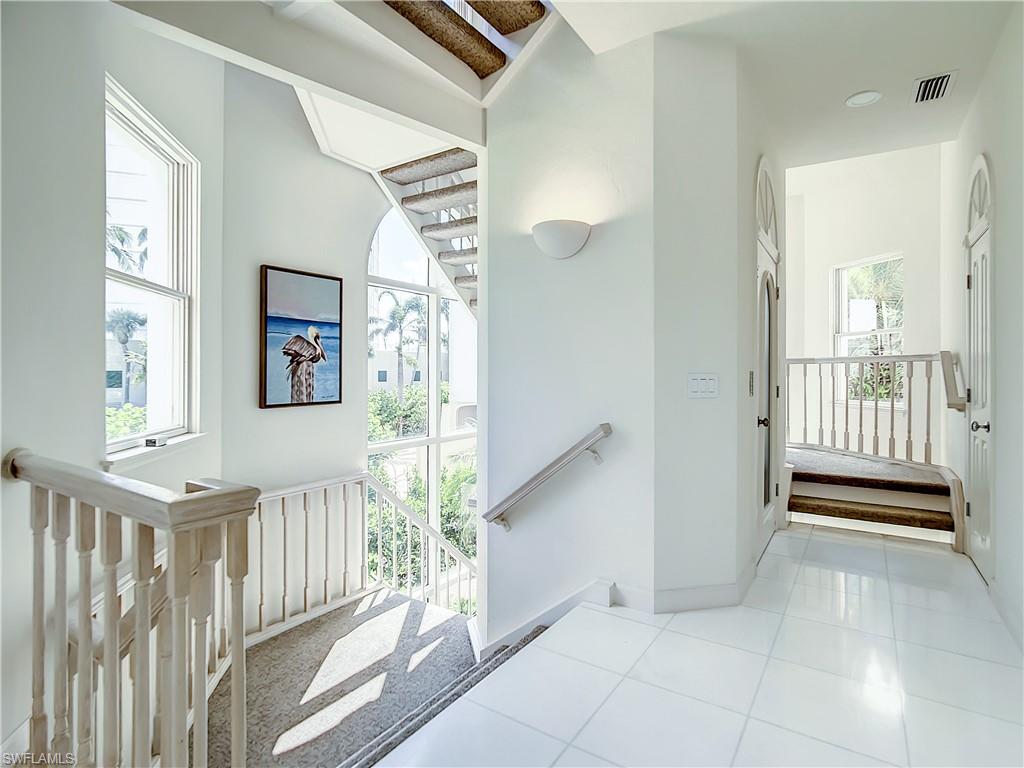 21 Casa Mar Lane, Unit 21 Naples, FL 34103 - Photo 11 of 47 a view of a hallway with windows and stairs