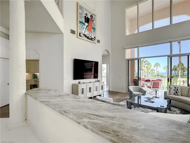 a living room with furniture and large windows