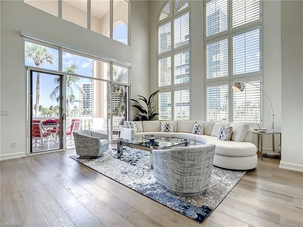 21 Casa Mar Lane, Unit 21 Naples, FL 34103 - Photo 16 of 47 a living room with furniture and large windows