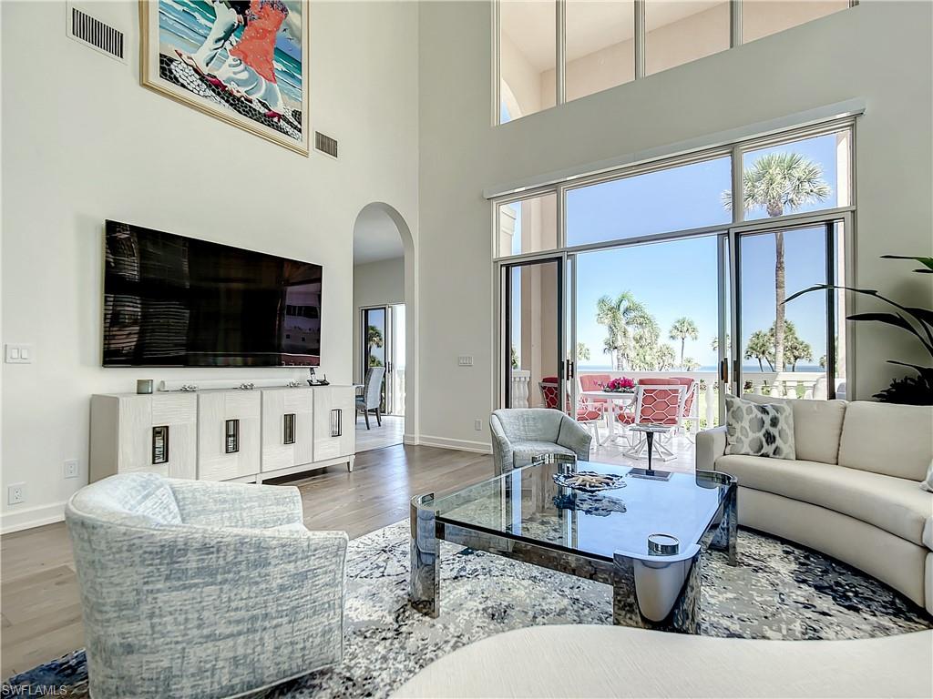 21 Casa Mar Lane, Unit 21 Naples, FL 34103 - Photo 17 of 47 a living room with furniture and a flat screen tv