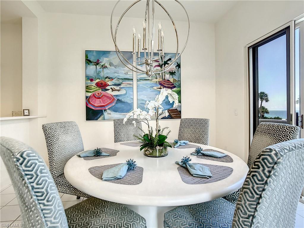 21 Casa Mar Lane, Unit 21 Naples, FL 34103 - Photo 20 of 47 a dining room with furniture and wooden floor