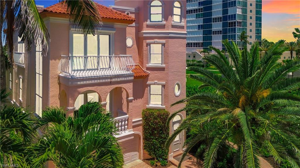 21 Casa Mar Lane, Unit 21 Naples, FL 34103 - Photo 2 of 47 a front view of a multi story building with yard