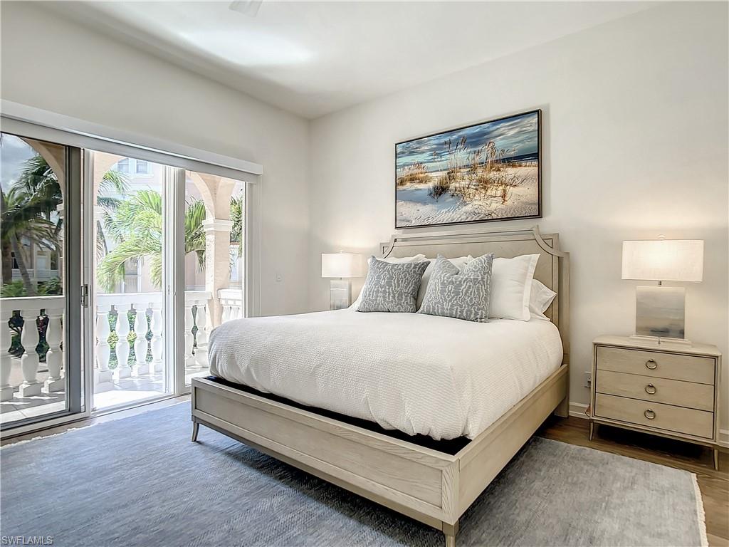 21 Casa Mar Lane, Unit 21 Naples, FL 34103 - Photo 22 of 47 a bedroom with a bed lamp and window