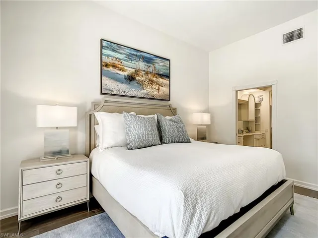 a bedroom with two beds and a large window