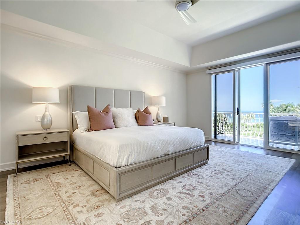 21 Casa Mar Lane, Unit 21 Naples, FL 34103 - Photo 28 of 47 a bedroom with a large bed and a large window