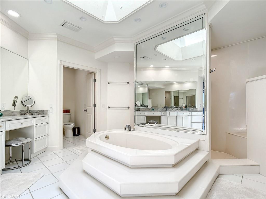 21 Casa Mar Lane, Unit 21 Naples, FL 34103 - Photo 30 of 47 a bathroom with a tub sink shower and mirror