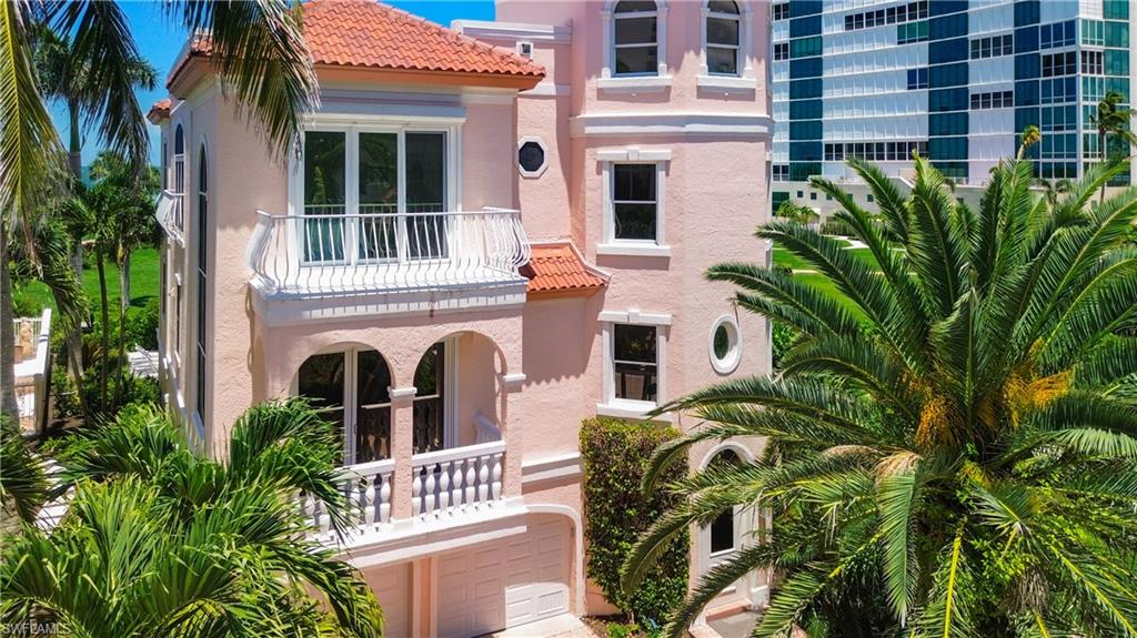 21 Casa Mar Lane, Unit 21 Naples, FL 34103 - Photo 3 of 47 a view of front door and potted plants