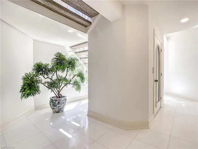 a open kitchen with stainless steel appliances kitchen island granite countertop a table and chairs in it