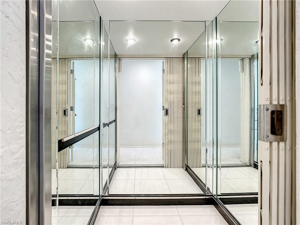 21 Casa Mar Lane, Unit 21 Naples, FL 34103 - Photo 36 of 47 a bathroom with a glass shower door