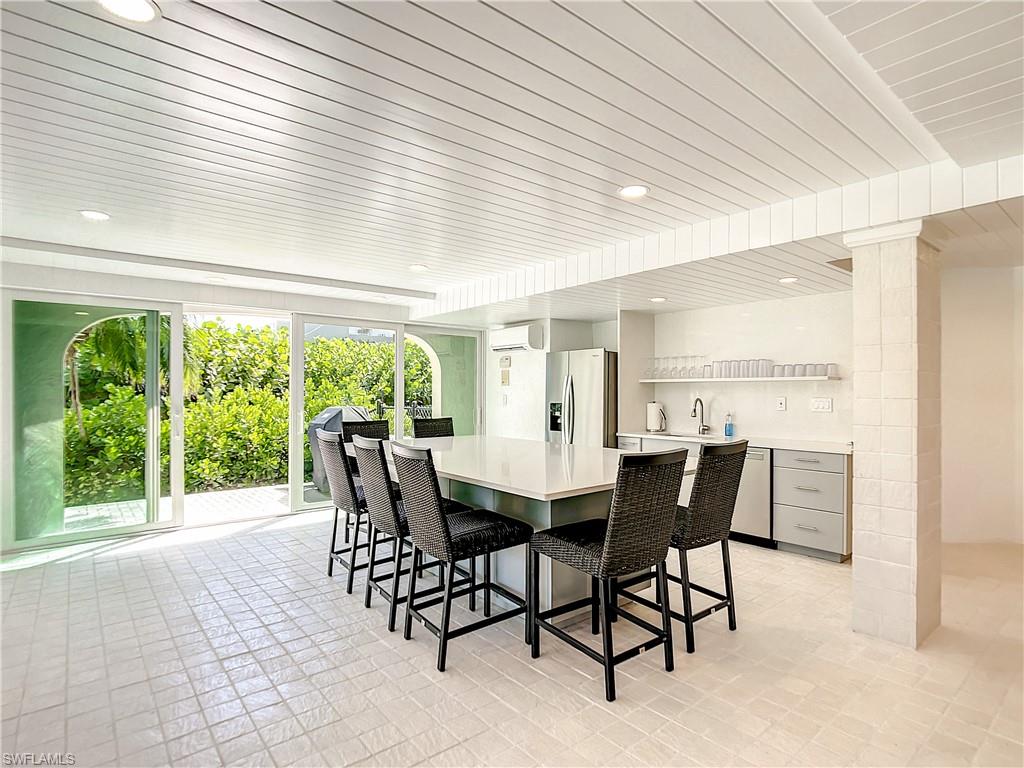 21 Casa Mar Lane, Unit 21 Naples, FL 34103 - Photo 39 of 47 a view of a dining room with furniture window and outside view