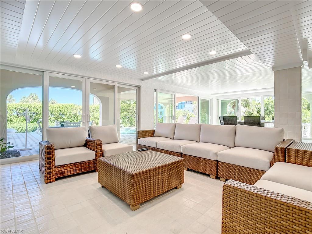 21 Casa Mar Lane, Unit 21 Naples, FL 34103 - Photo 40 of 47 a living room with furniture and a large window