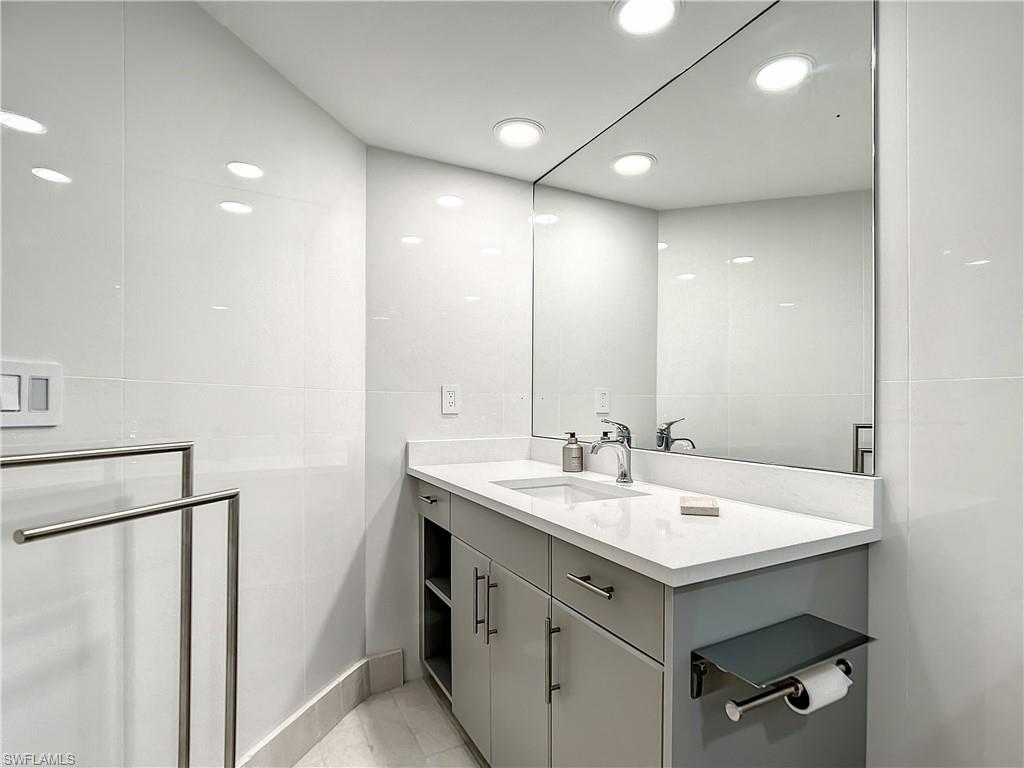 21 Casa Mar Lane, Unit 21 Naples, FL 34103 - Photo 42 of 47 a view of a sink a mirror and cabinets