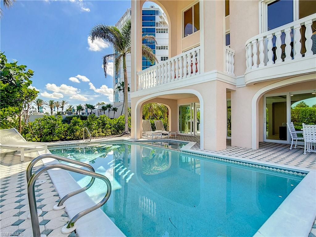 21 Casa Mar Lane, Unit 21 Naples, FL 34103 - Photo 45 of 47 a view of a house with swimming pool and sitting area