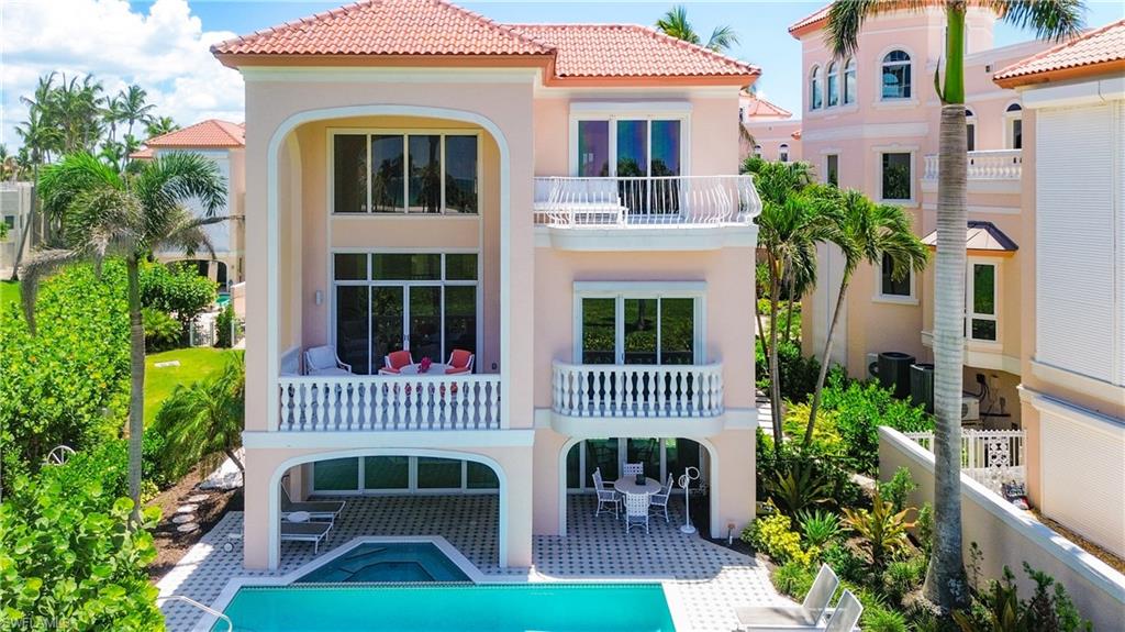 21 Casa Mar Lane, Unit 21 Naples, FL 34103 - Photo 46 of 47 a front view of a house with garden and porch