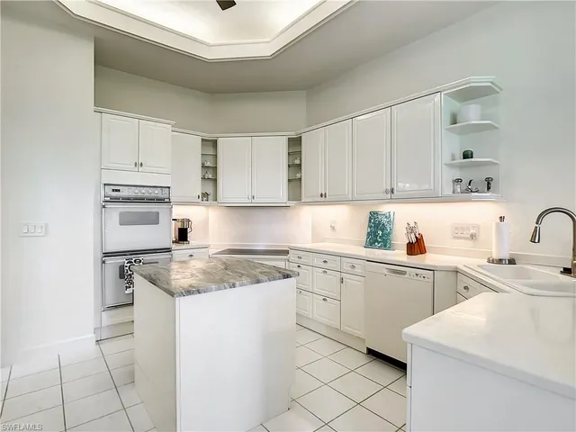 a kitchen with stainless steel appliances granite countertop a refrigerator and a stove