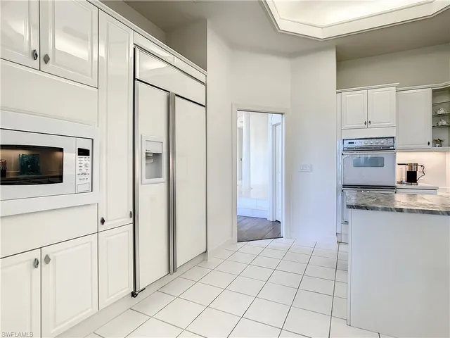a kitchen with stainless steel appliances granite countertop a sink dishwasher and cabinets with wooden floor