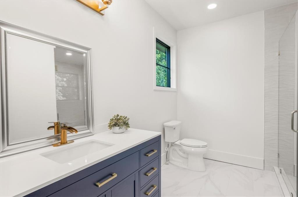 494 River Overlook Road Dawsonville, GA 30534 - Photo 32 of 96 a bathroom with a sink a toilet and mirror